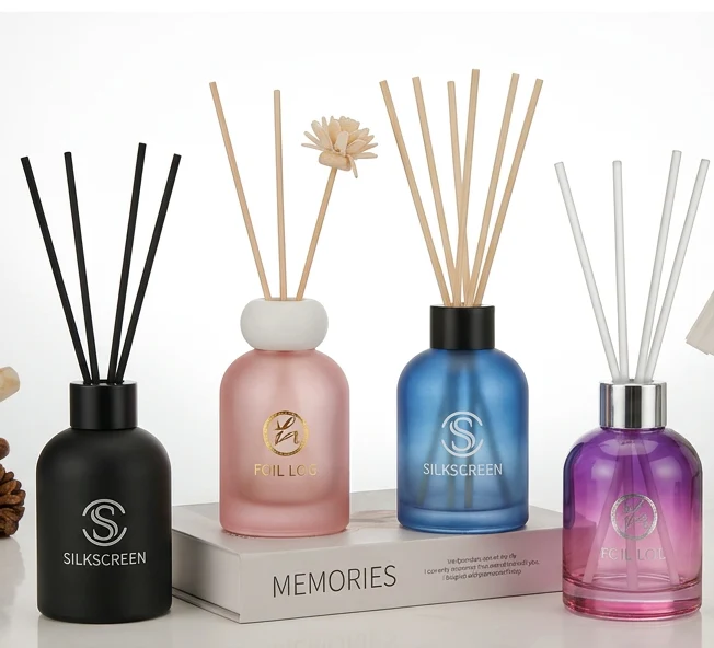 round colored glass diffuser bottle with reeds