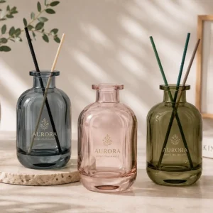 Colored glass reed diffuser bottles in smoky grey pink and olive green